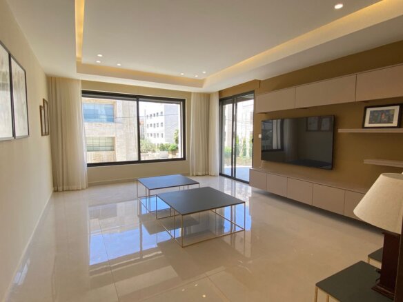 Bright, modern living room with large windows, cream curtains, and two square coffee tables on a glossy tile floor when facing a wall-mounted TV unit.